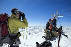 Man taking summit photo of group
